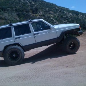TJ Flares.  The rear tires don't hit!
