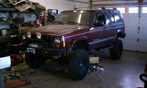 As it sat in Eric's (trailratethis) garage after he did a lot of work on it for me while I was deployed to Iraq.

Probably close to 6" of lift with 31