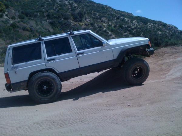 TJ Flares.  The rear tires don't hit!